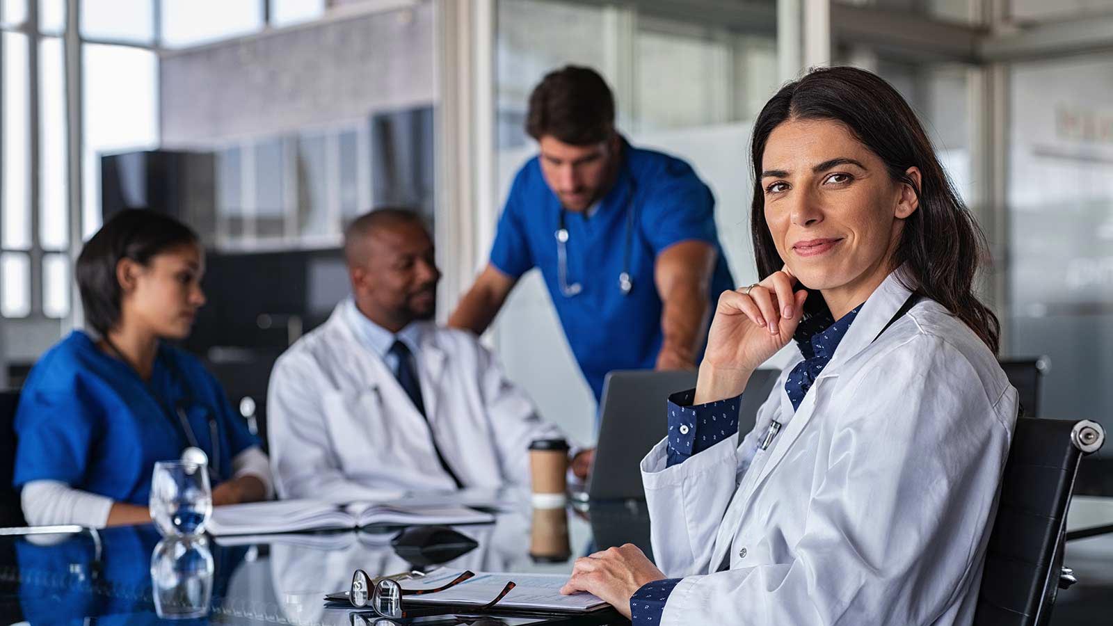 A group of professional doctors sit in a break room