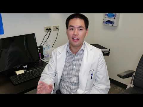 Optometrist Wesley Chew sitting in his Tustin office