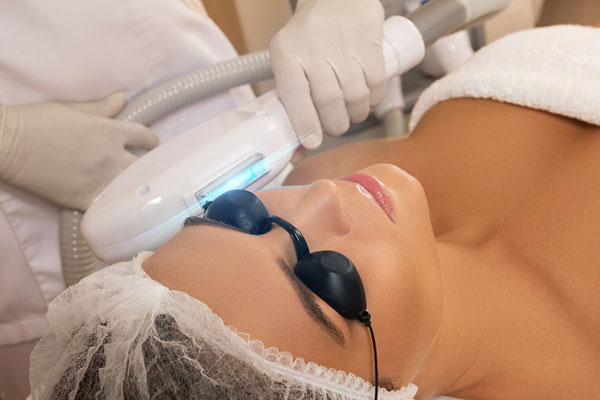 Woman with goggles receiving IPL treatment to treat dry eye