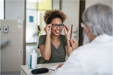 women getting her glasses with the help of an optometrist
